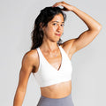 Sleek Silhouette Yoga Bra in White – breathable sports bra with fine cross-back straps and elegant back design – provides lightweight support and soft comfort with a second-skin feel for yoga and pilates.