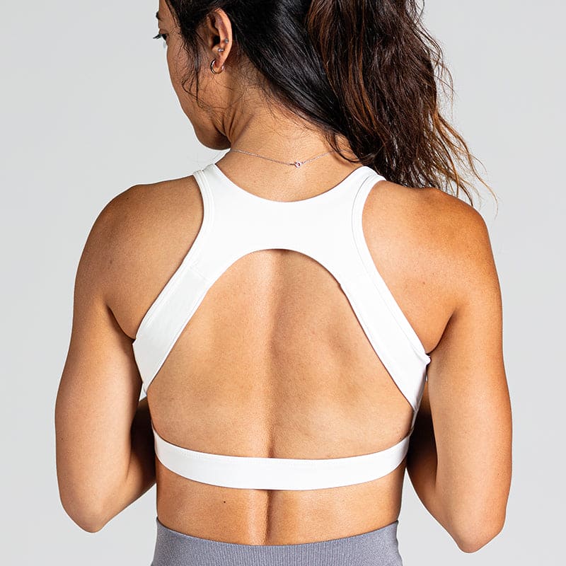 Sleek Silhouette Yoga Bra in White – breathable sports bra with fine cross-back straps and elegant back design – provides lightweight support and soft comfort with a second-skin feel for yoga and pilates.